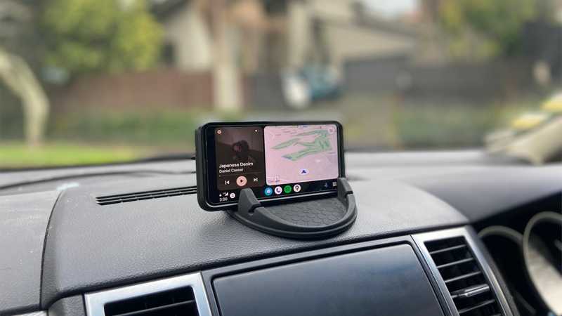 My phone in a wireless charging mount positioned center atop the vehicle dash.