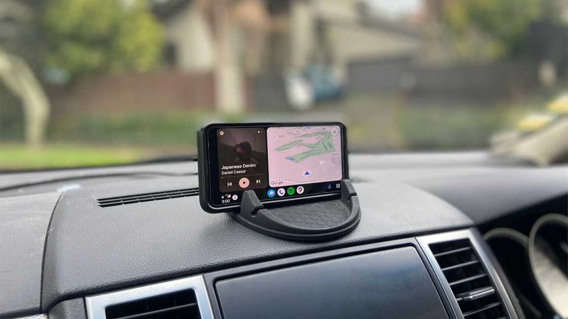 My phone in a wireless charging mount positioned center atop the vehicle dash.